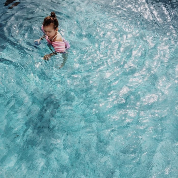 baby using puddle jumper life jacket in pool