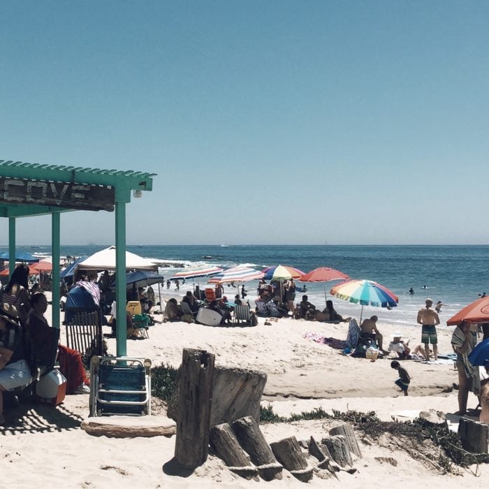 busy summer day at the beach with summer shade