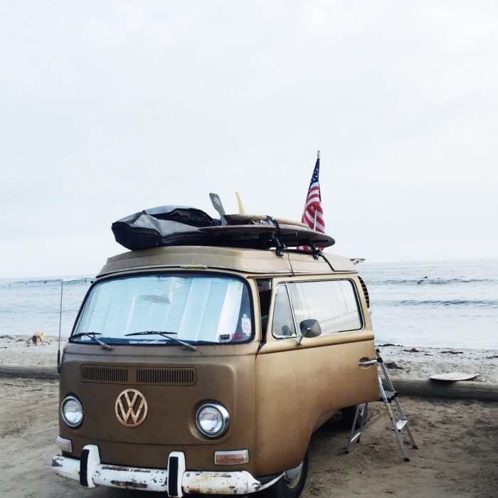 vintage VW van on the beach with american flag