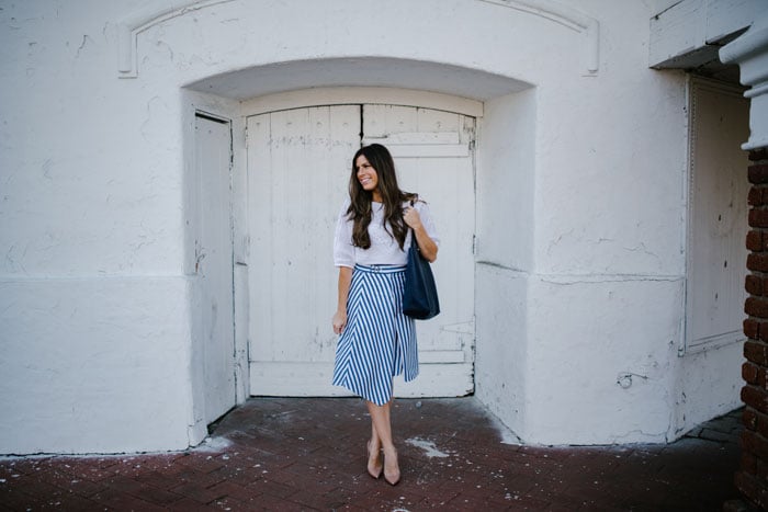 white blouse and striped blue skirt