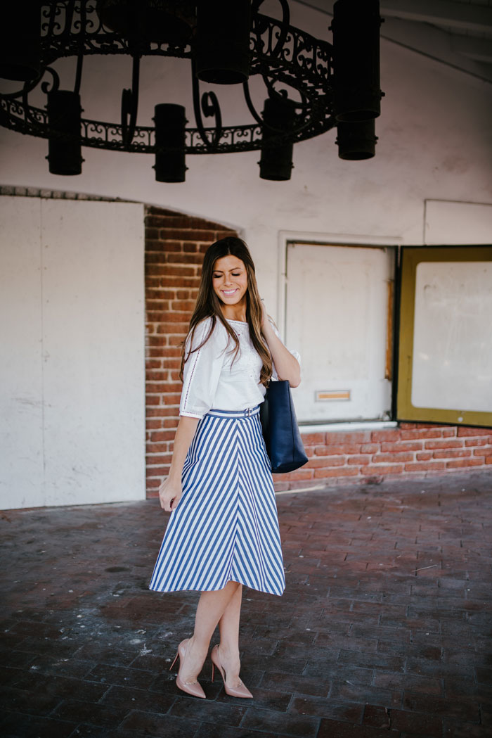 white blouse and striped blue skirt