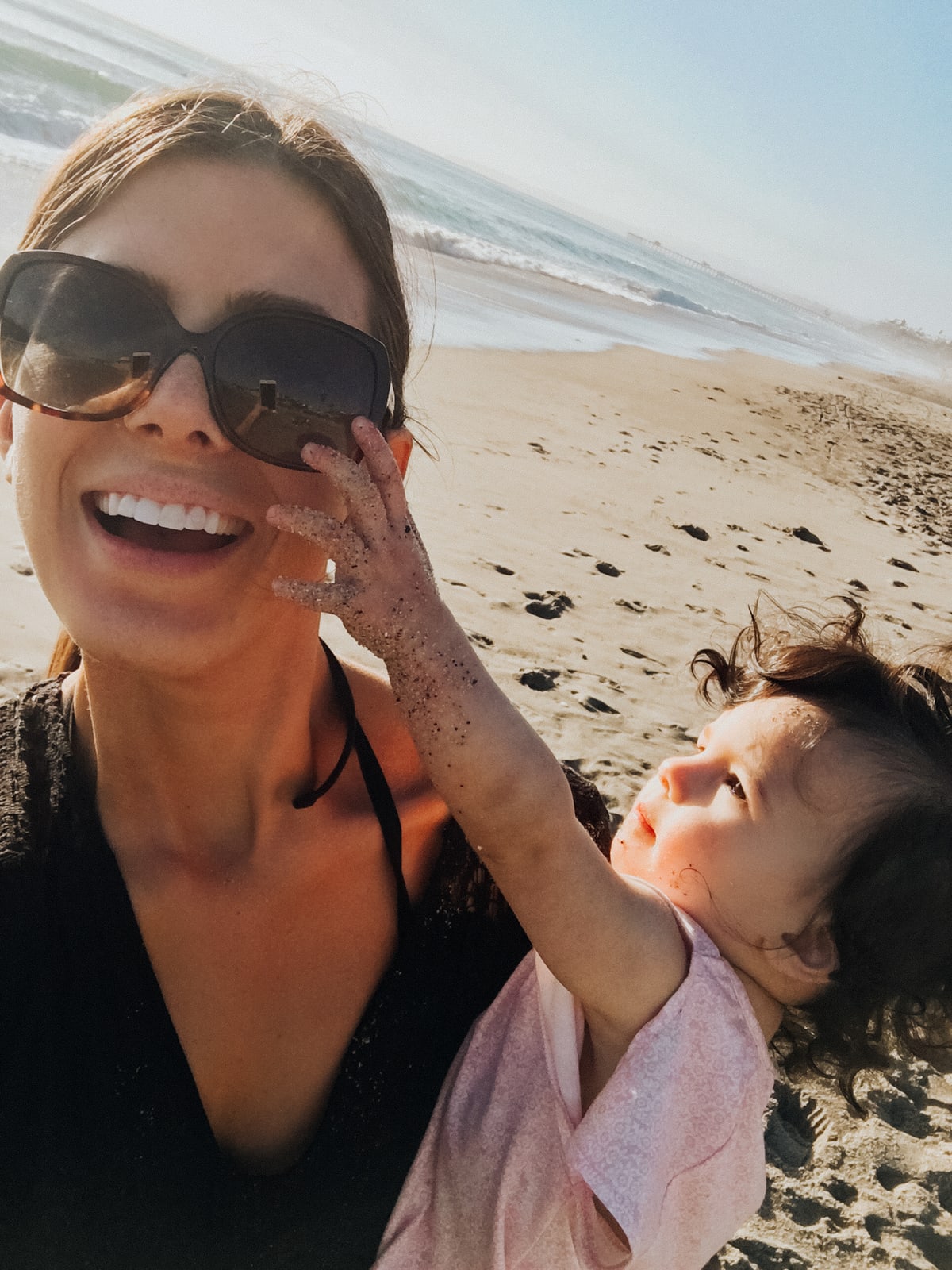 Corrine wearing the Tory Burch sunnies at the beach