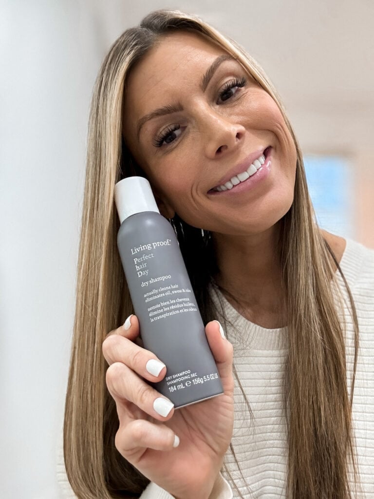 corrine holding living proof dry shampoo