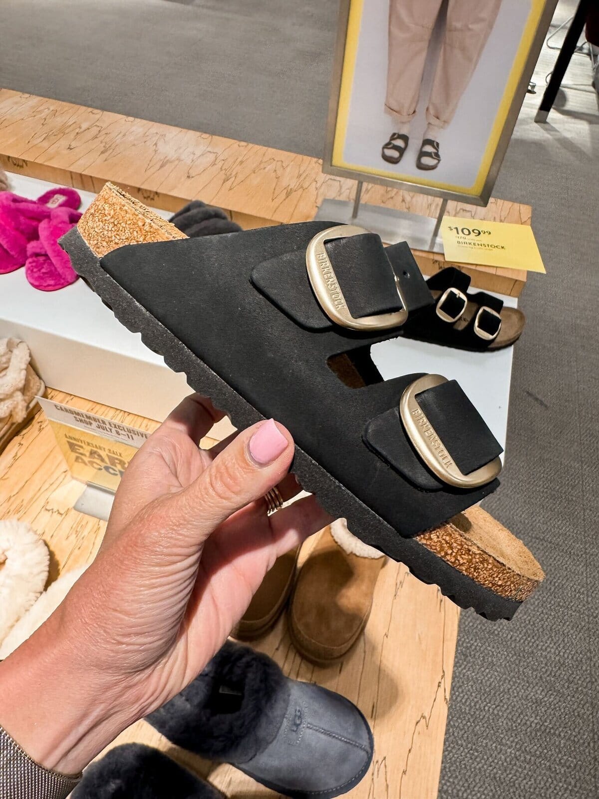 Corrine holding Birkenstock Arizona Big Buckle Slide Sandal in black