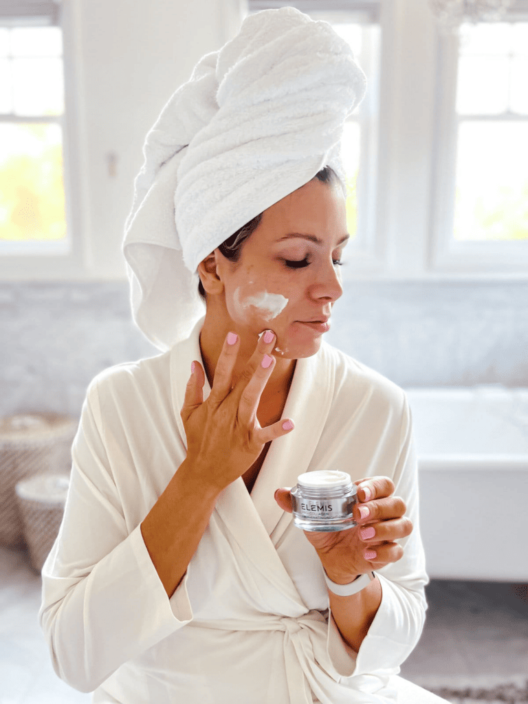 Corrine is applying Elemis Pro Collagen Cream in her face