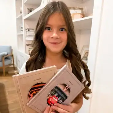 Millie-holding-Chatbooks-scaled