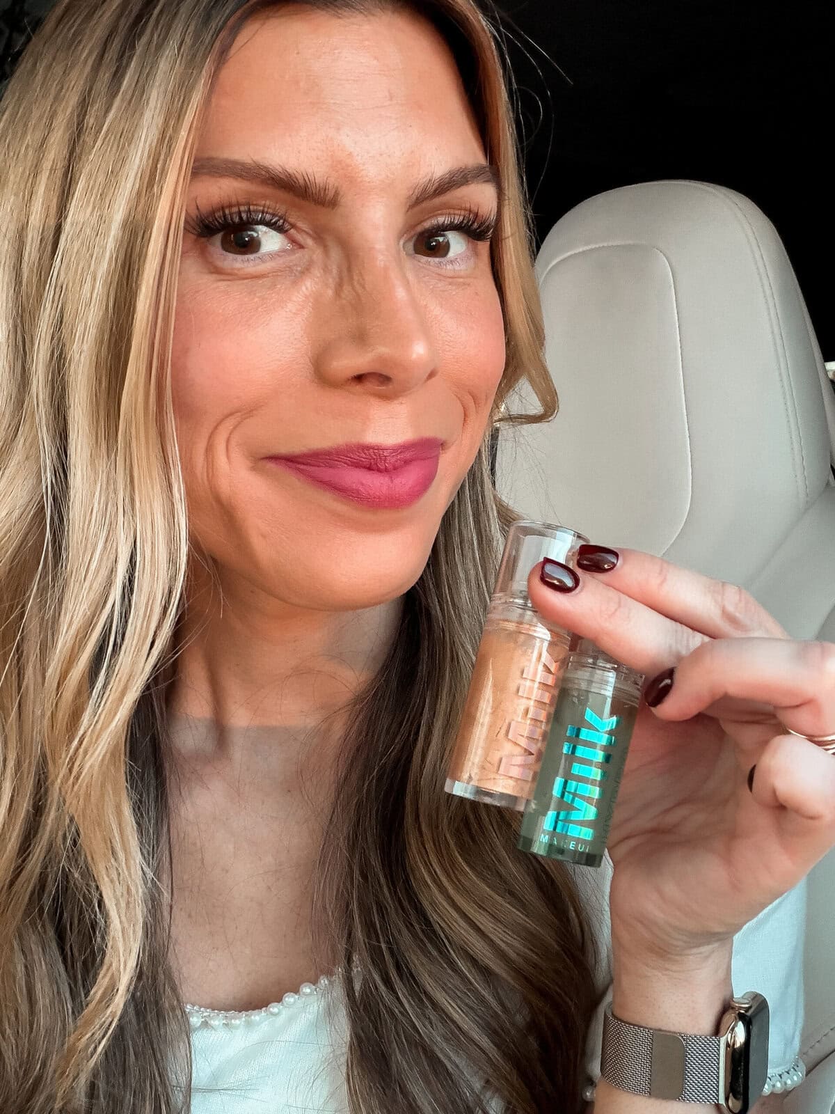 Corrine holding Milk Makeup Hydrogrip Primer duo