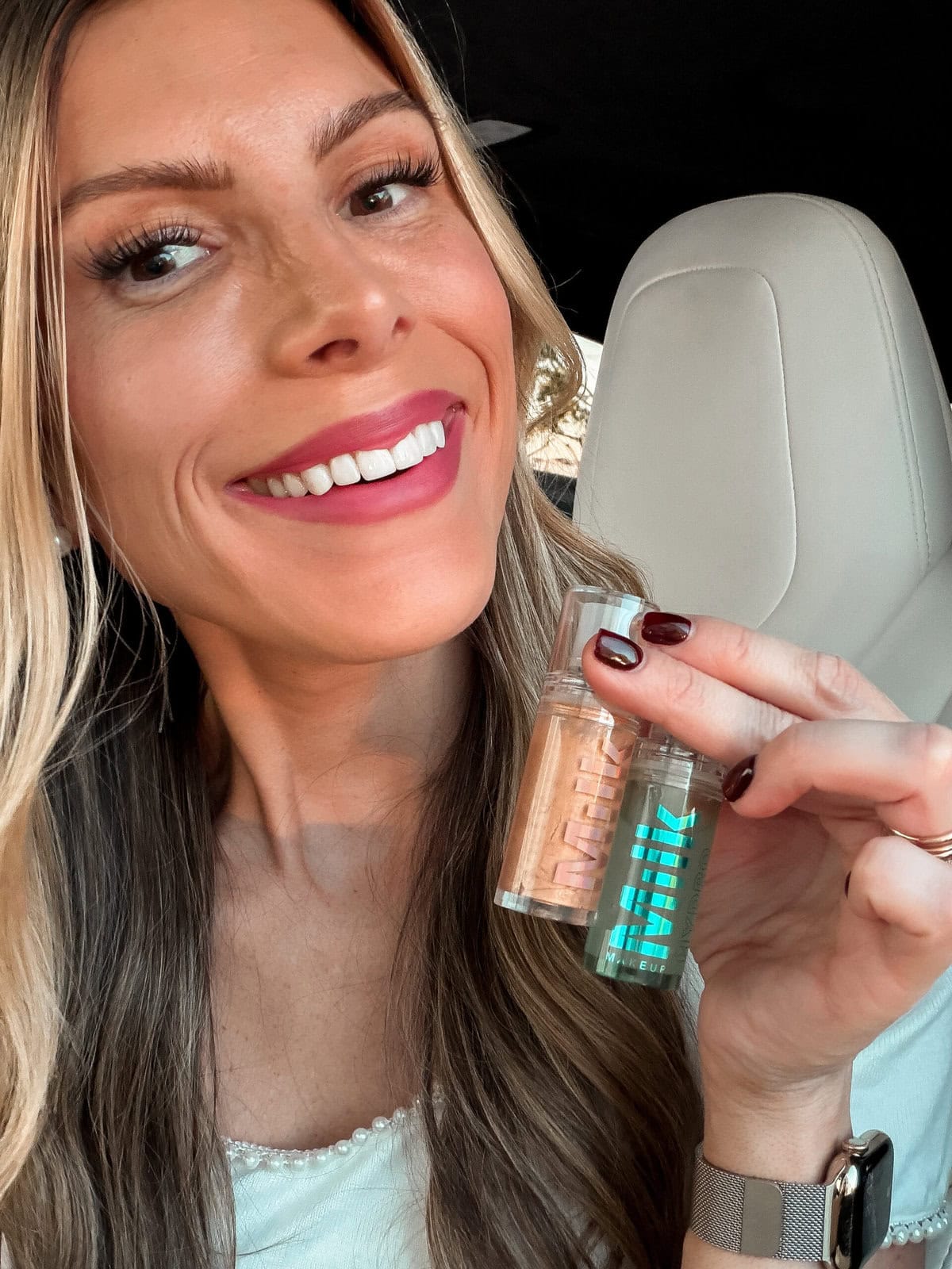 Corrine holding Milk Makeup Primer duo