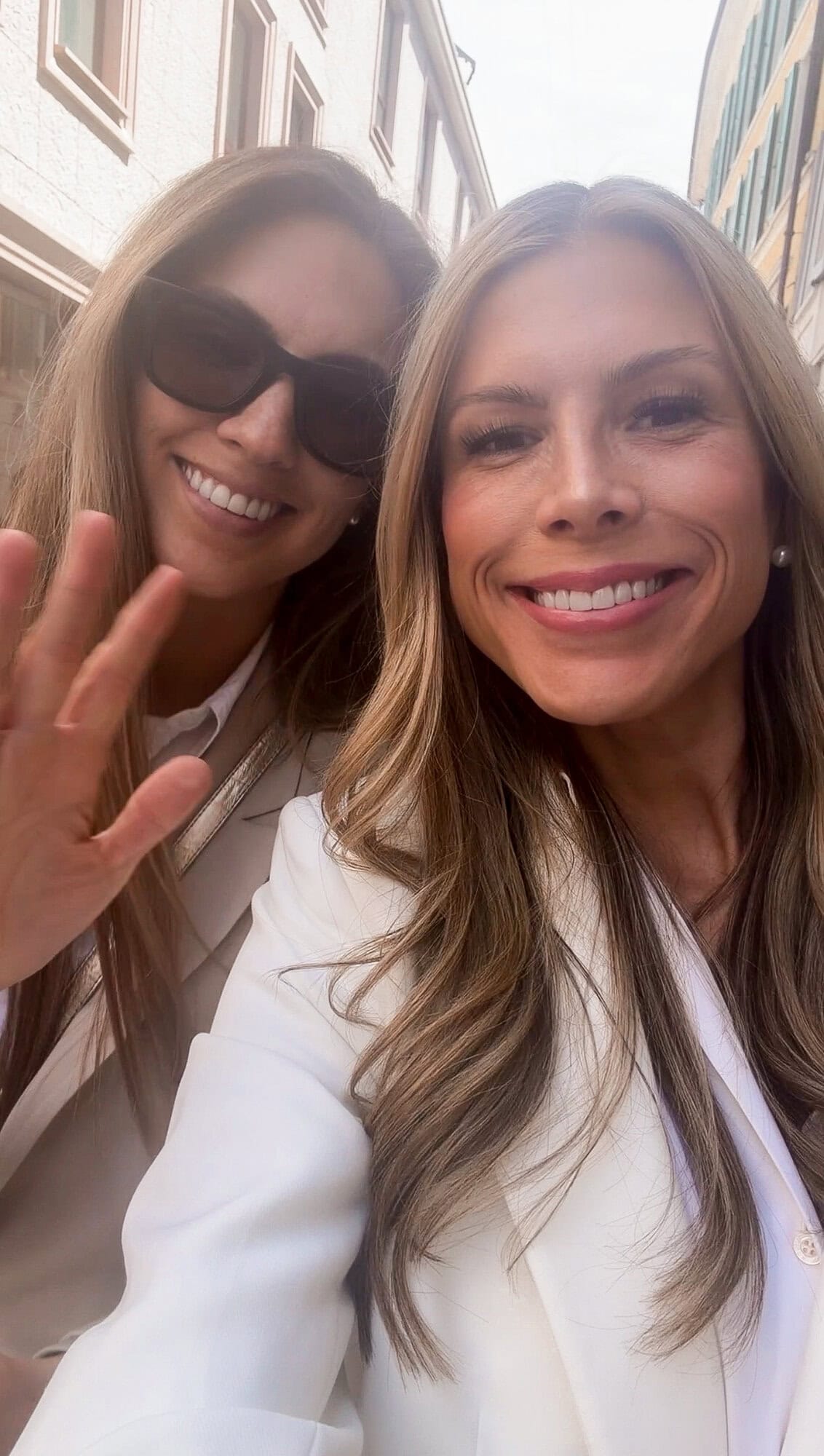 Selfie with my sister on a sunny Milan street during our trip to Italy