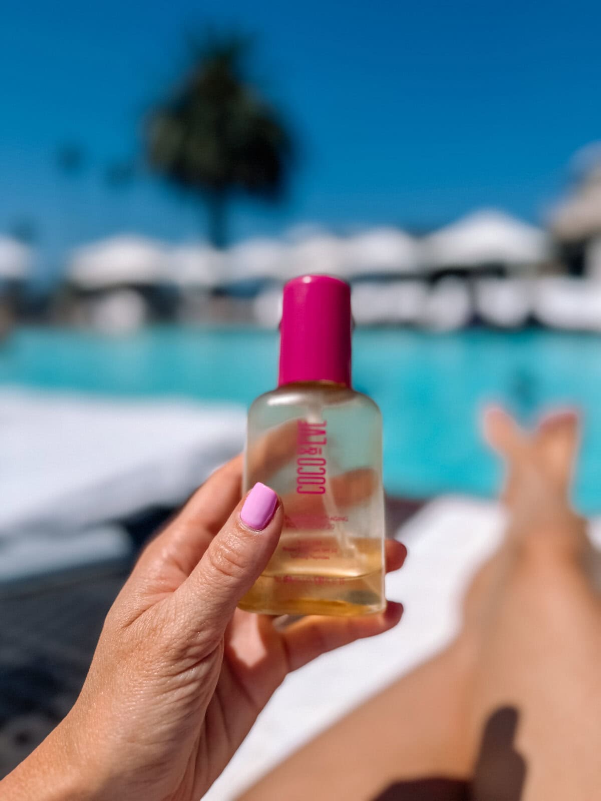 Coco & Eve Tan Boosting Body Oil SPF 20 by the pool