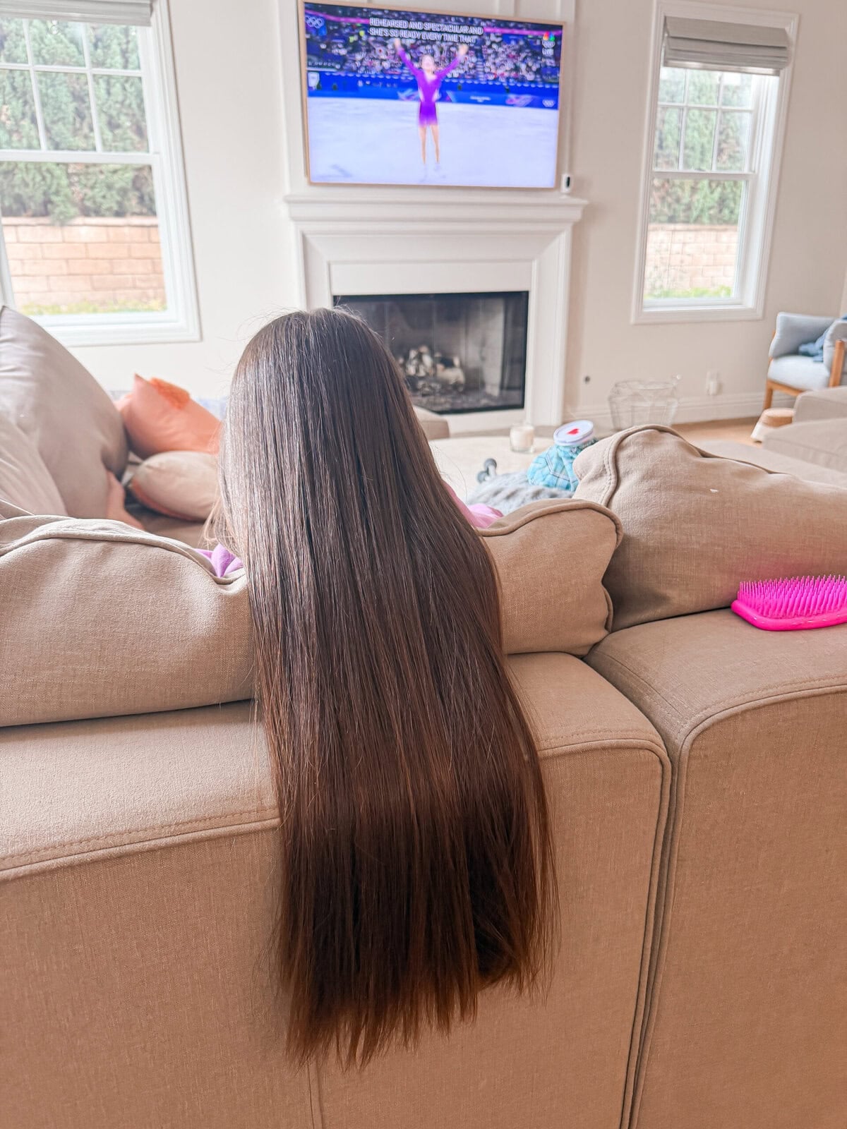 Daughter with long thick hair freshly straightened with the Tymo straightening brush