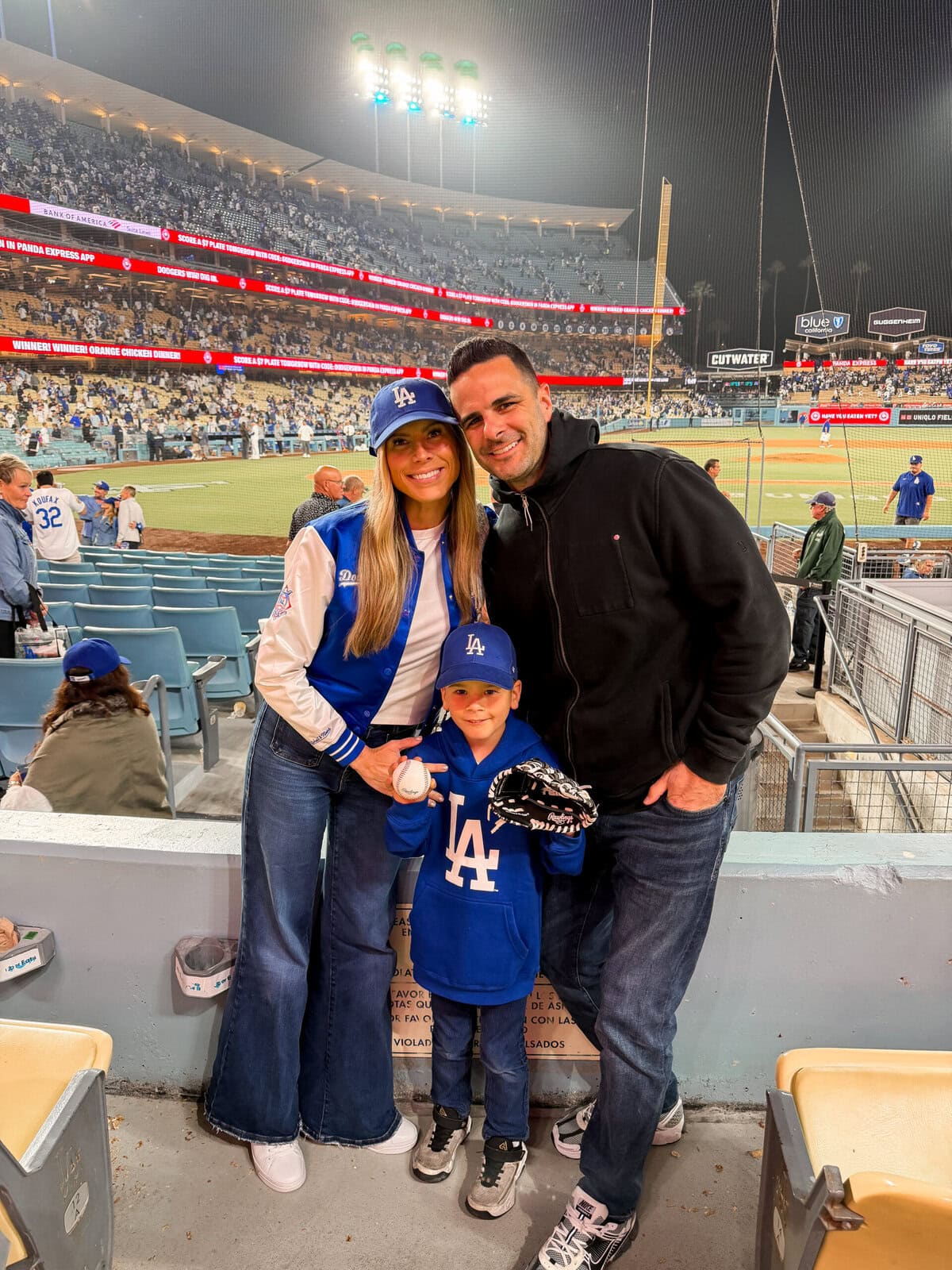 Corrine in the Mitchell & Ness MLB Dodgers letterman jacket with Harry at a Dodgers game