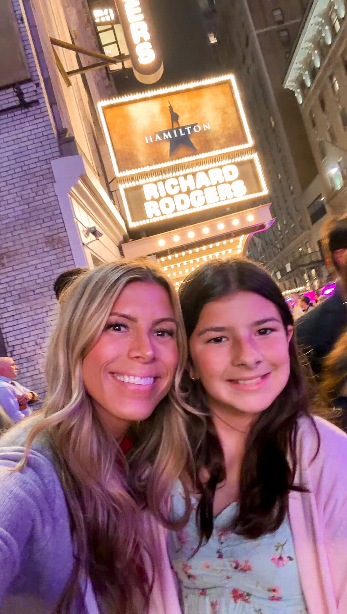 Mom and tween daughter selfie outside the Richard Rodgers Theater with the Hamilton sign on Broadway in NYC