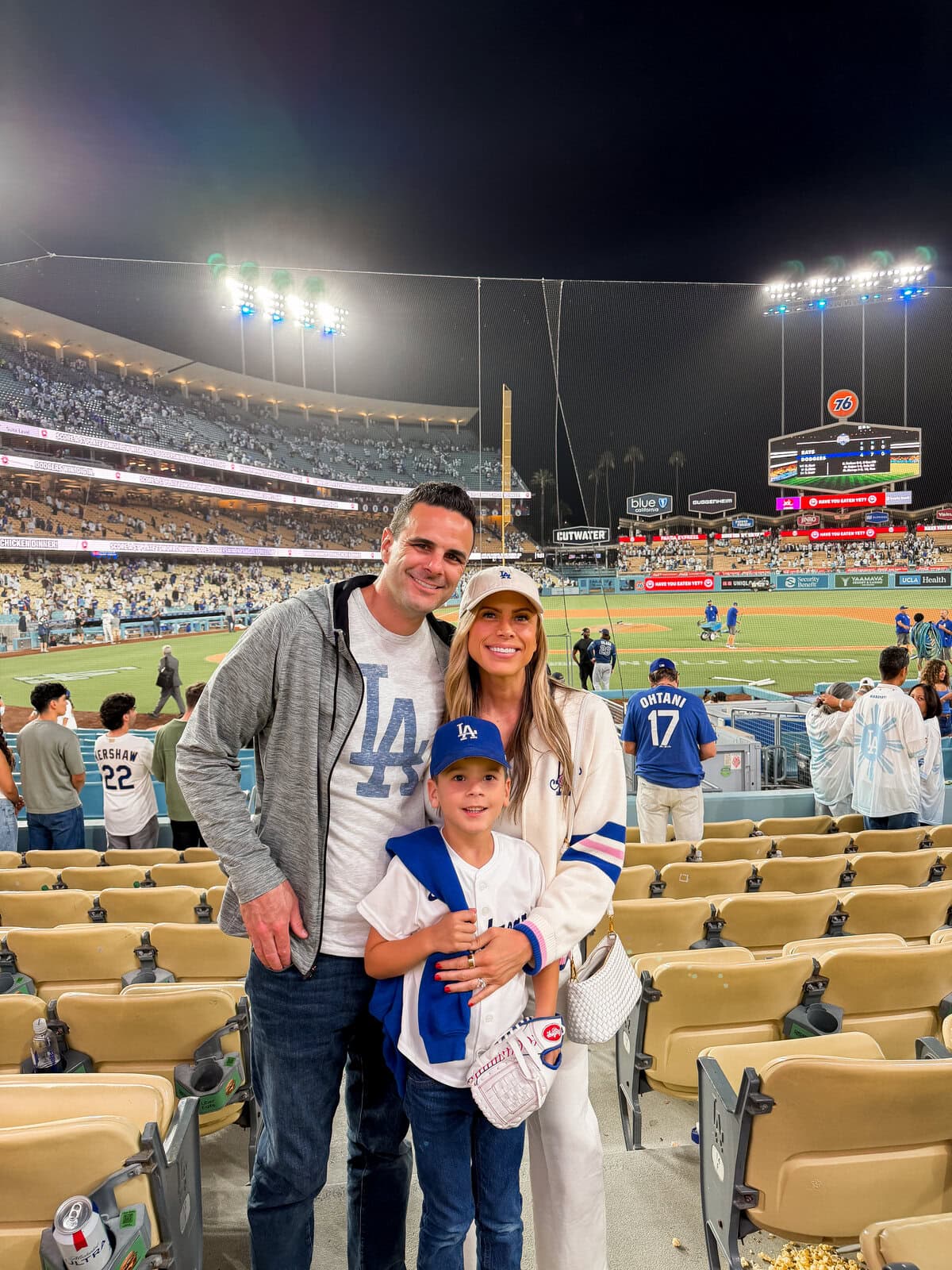 Corrine in cream Dodgers outfit at Dodger Stadium with Harry