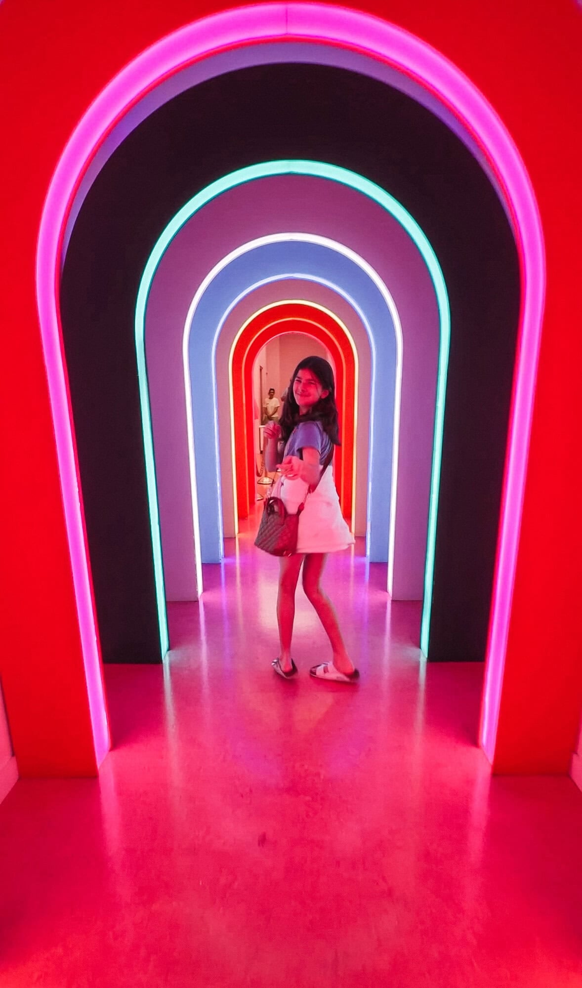 Rainbow neon arched tunnel installation inside the Museum of Ice Cream in NYC