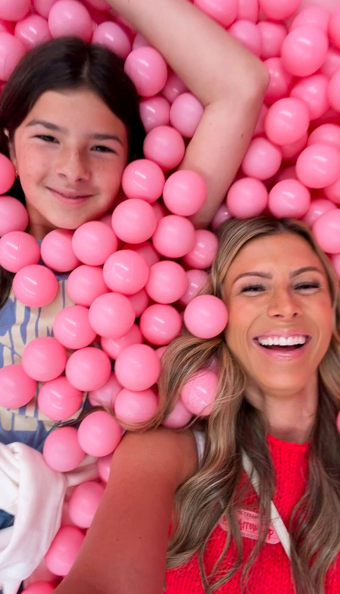 Tween daughter playing in the iconic pink sprinkle ball pit at the Museum of Ice Cream
