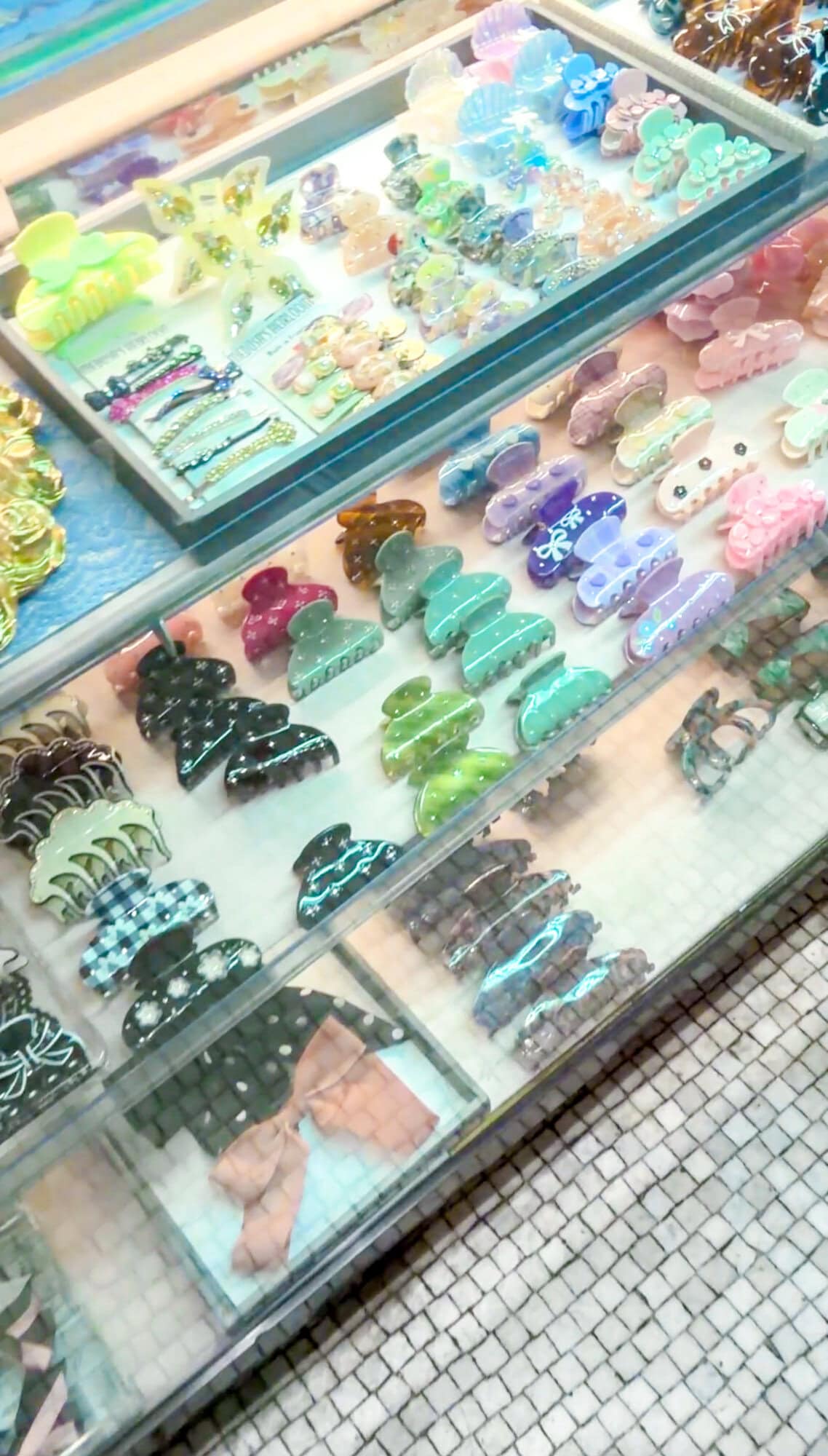 Display case of colorful hair claw clips and hair accessories at C.O. Bigelow pharmacy in NYC