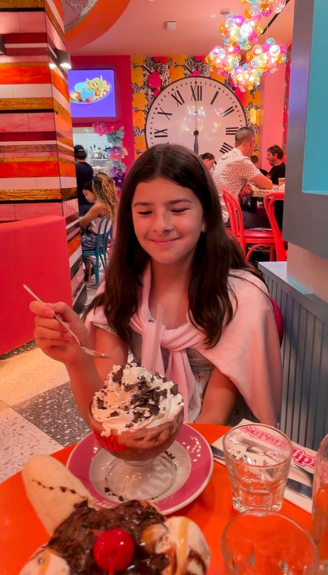 Tween daughter enjoying a frozen hot chocolate sundae at Serendipity in Times Square NYC