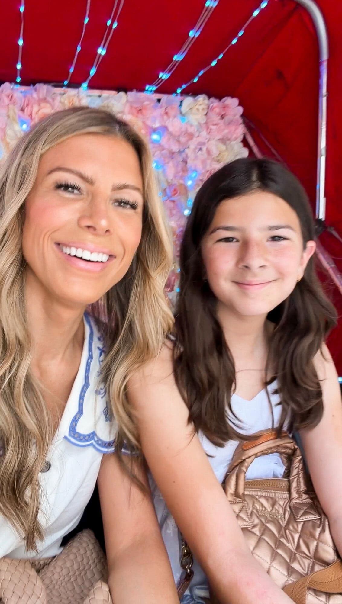 Mom and tween daughter in a colorful flowery NYC pedicab bicycle carriage selfie
