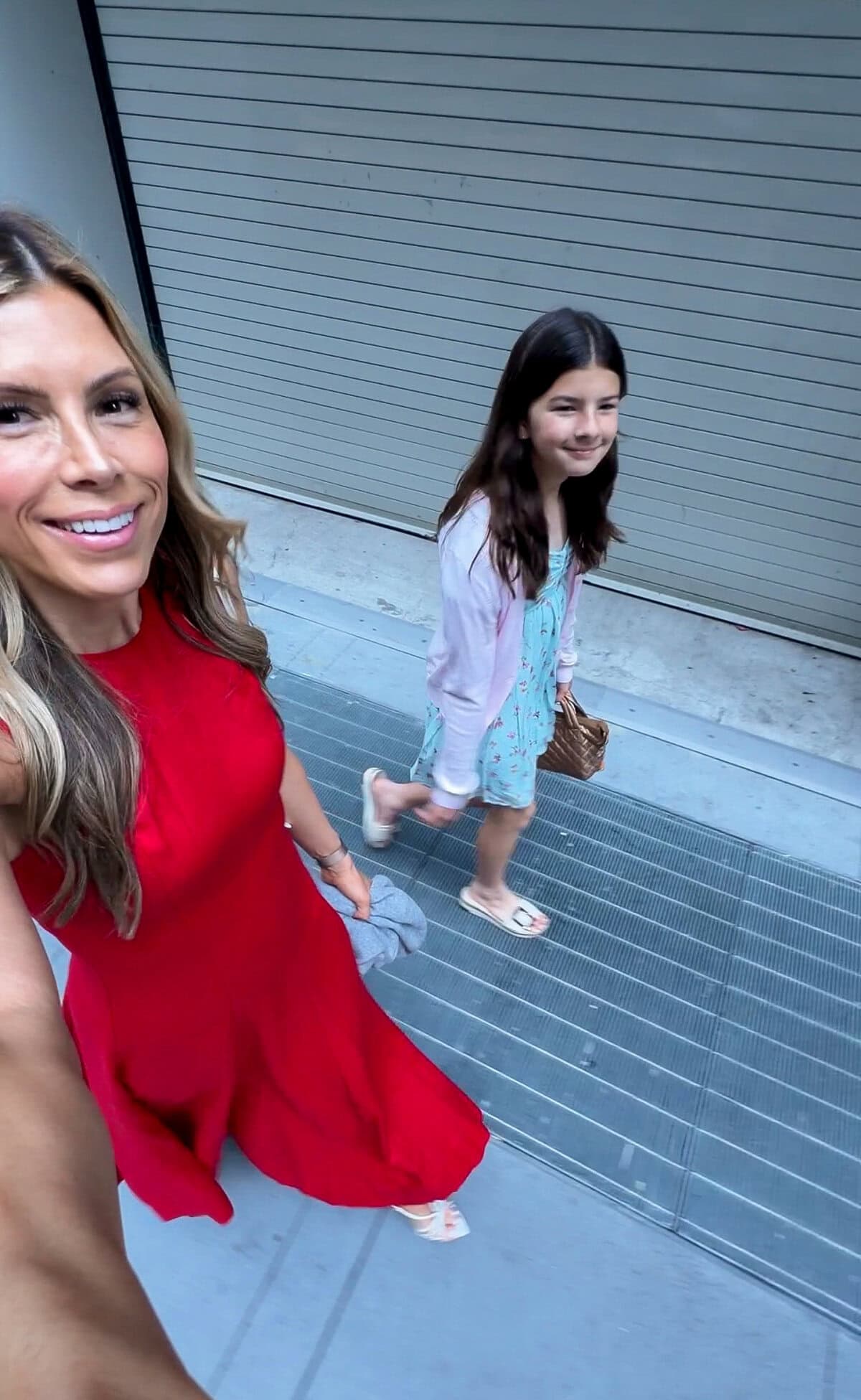 Corrine in the Reformation Cecilia red linen dress walking with her daughter