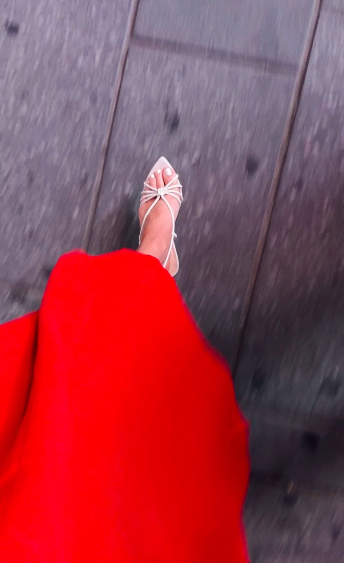 Cream Maeve strappy pointed-toe heels in action with the red linen dress