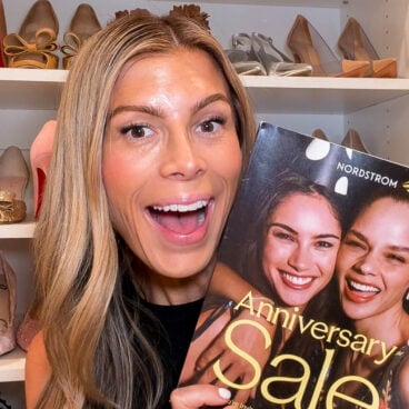 Corrine Stokoe holding the Nordstrom Anniversary Sale catalog in her closet