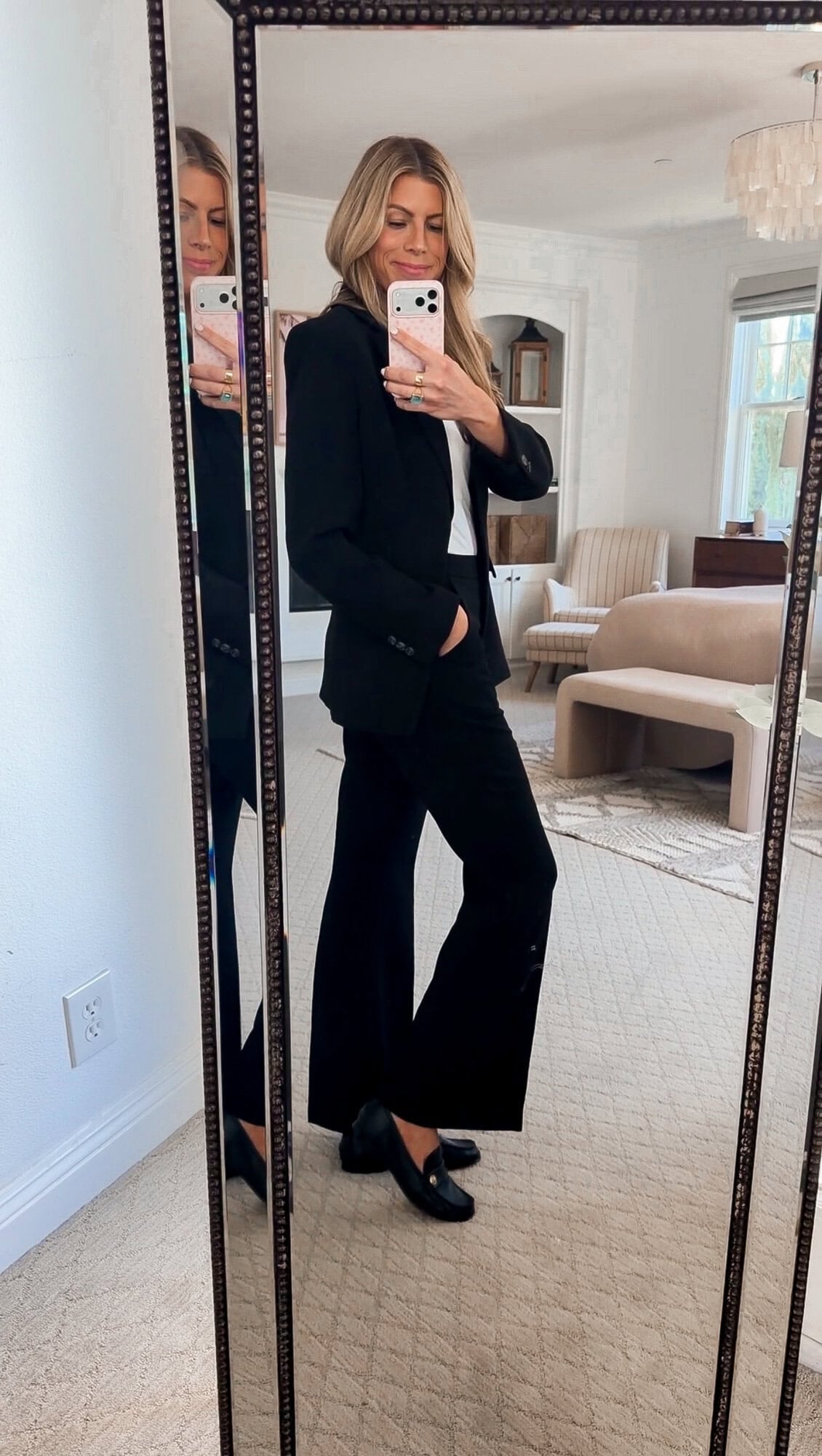 me wearing the Open Edit Curator fitted blazer open over a white tank with black flare trousers