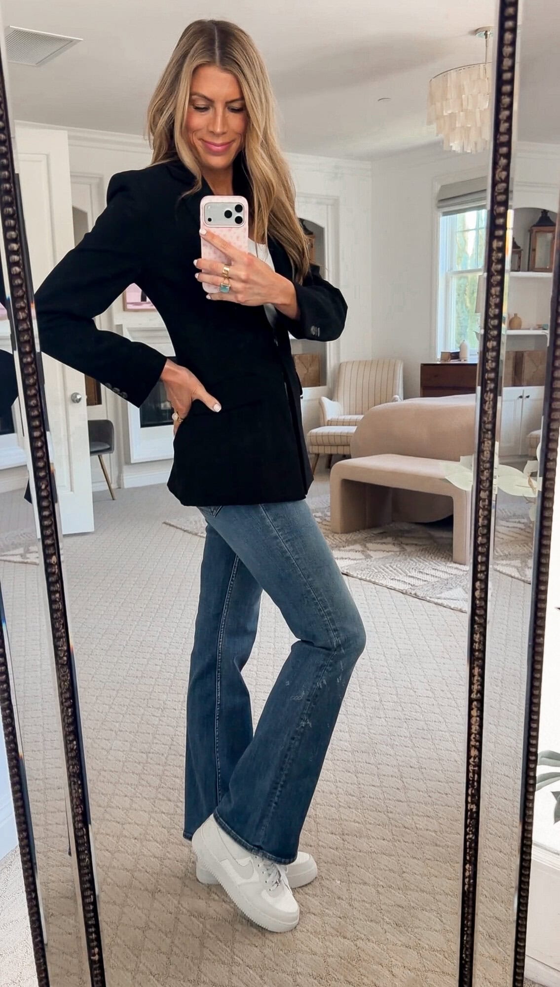 me wearing the seamless shelf bra layering tank under the blazer with bootcut jeans