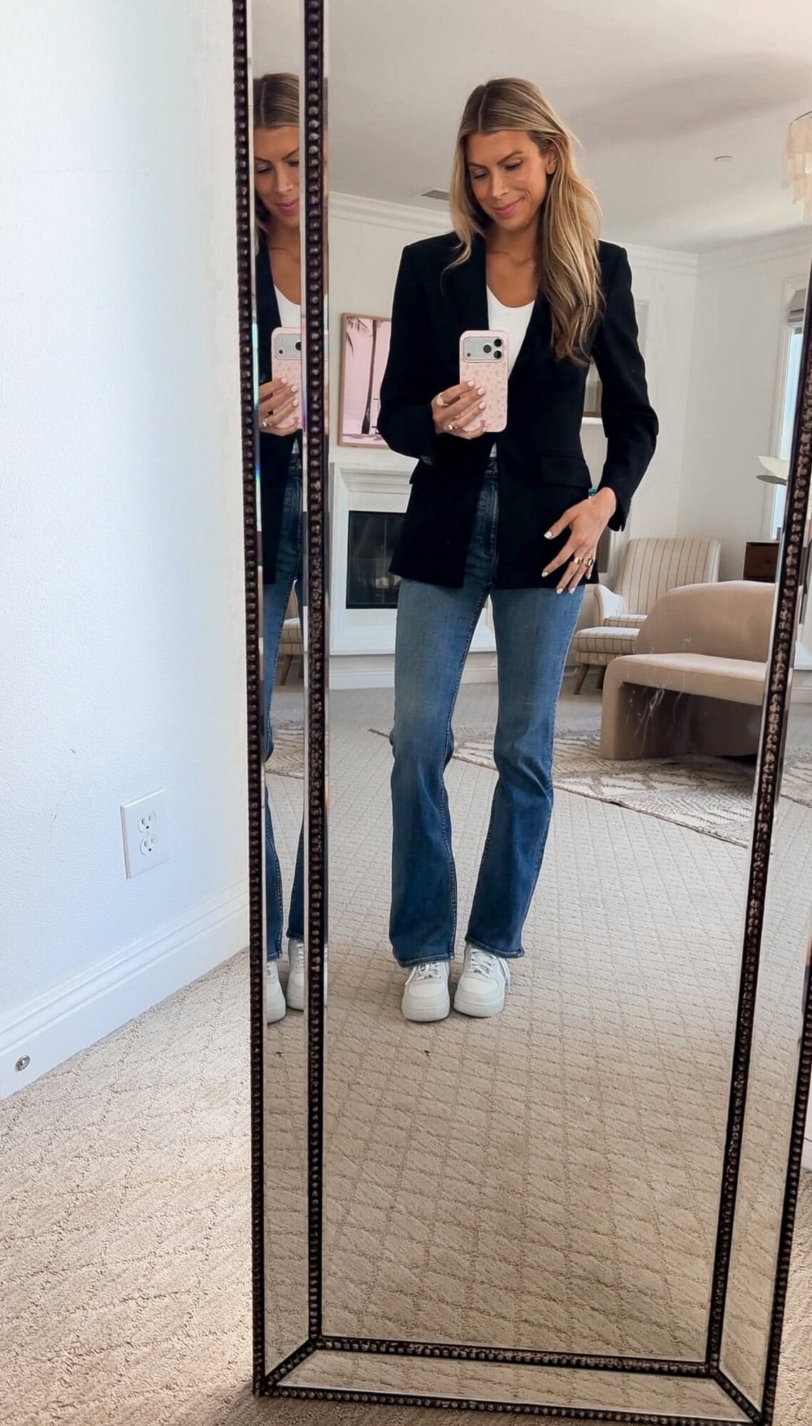 me wearing the black blazer with rag and bone bootcut jeans and white Nike Air Force 1 sneakers