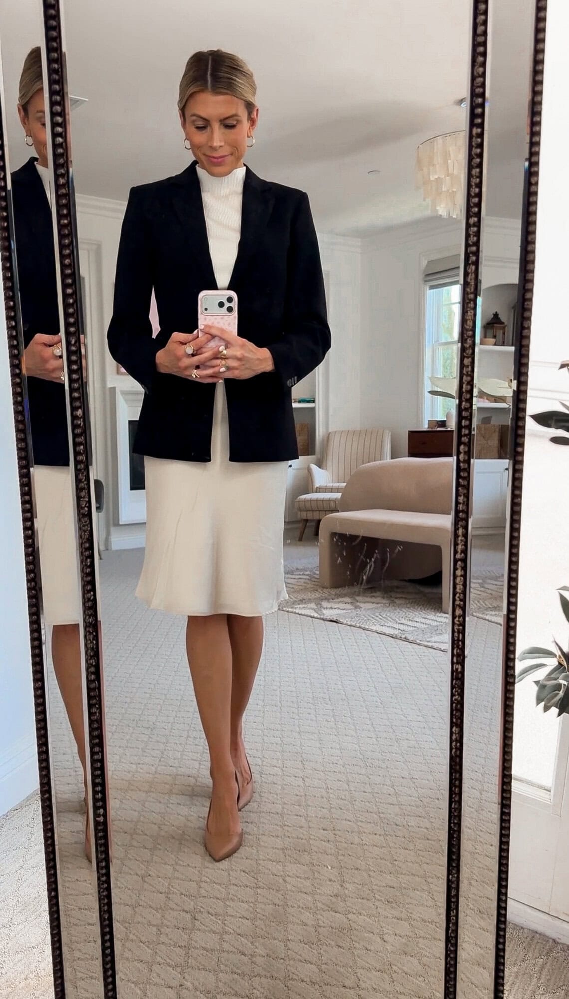 me wearing the WAYF satin slip skirt with a mock neck sweater and the blazer